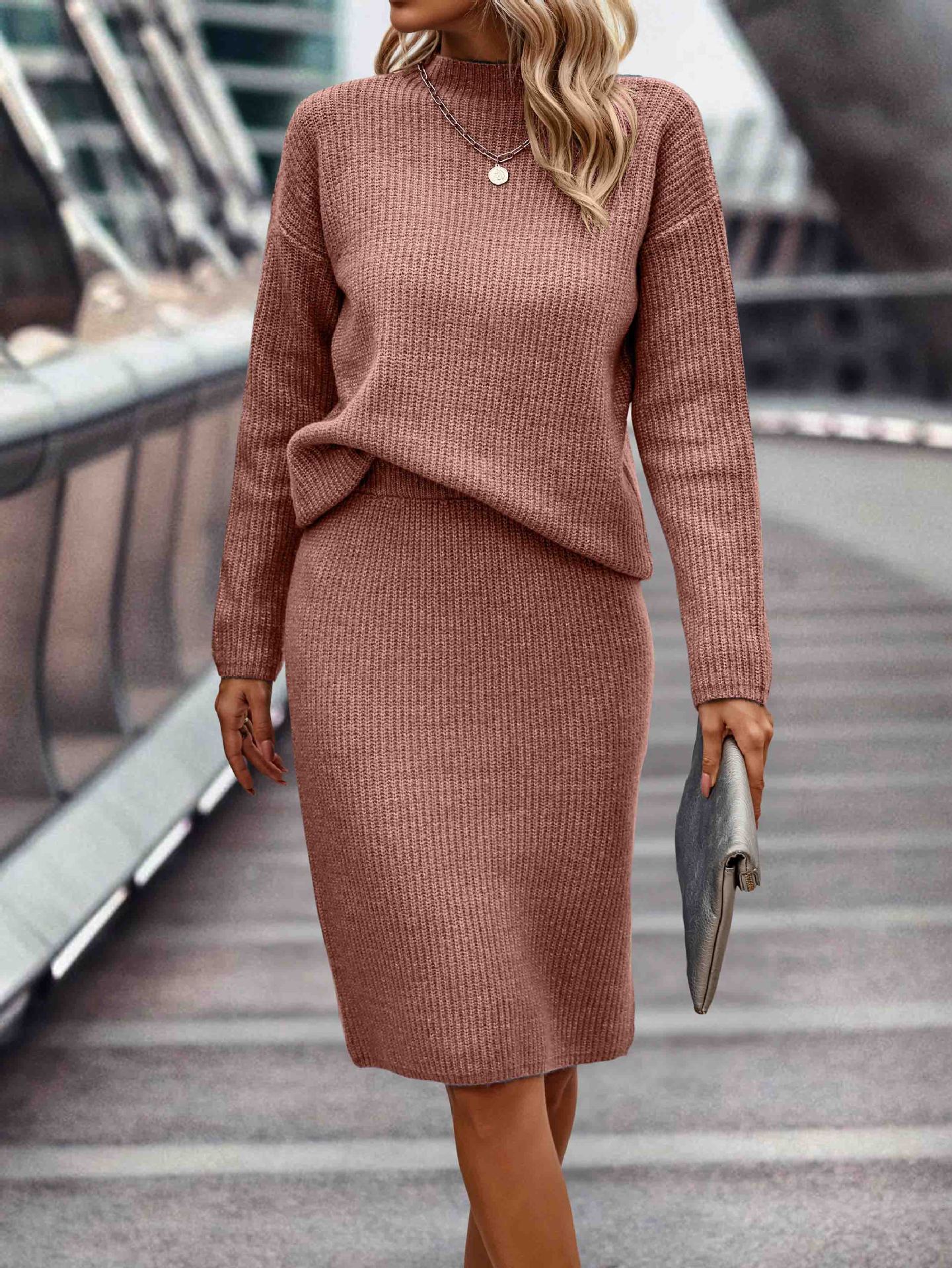Elegant seasonal ensemble featuring a sleek, long-sleeved knit top with a high neckline, paired with coordinating bottoms for women.