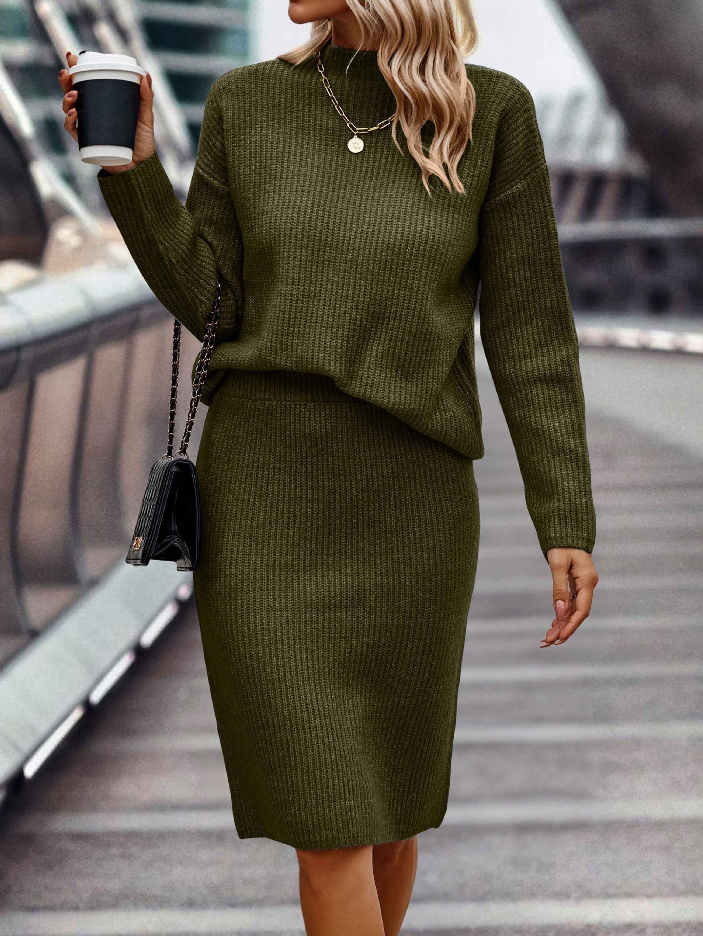 Elegant seasonal ensemble featuring a sleek, long-sleeved knit top with a high neckline, paired with coordinating bottoms for women.