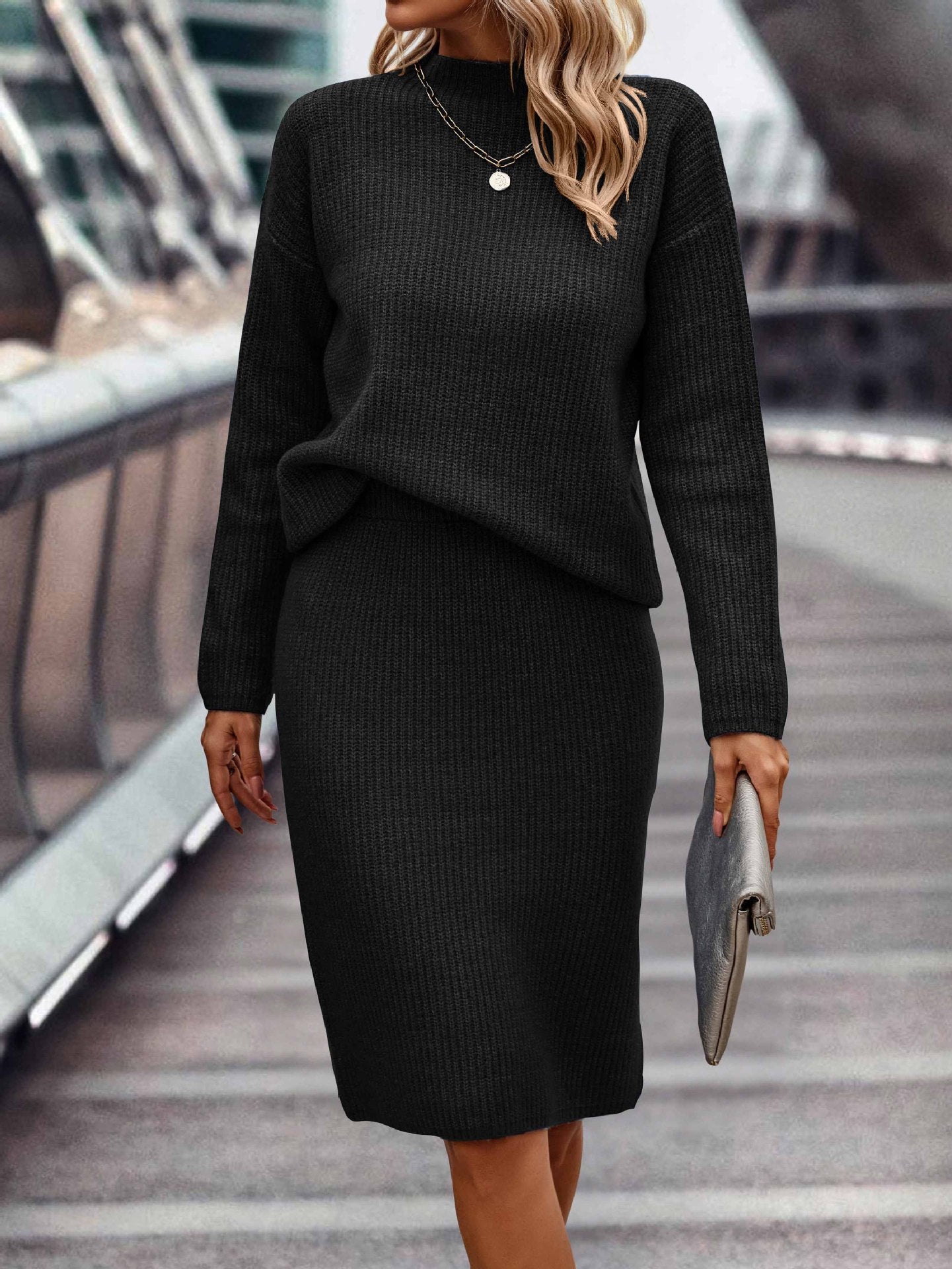 Elegant seasonal ensemble featuring a sleek, long-sleeved knit top with a high neckline, paired with coordinating bottoms for women.